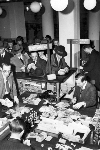 Germans exchanging old into new currency after the German Currency Reform of June 20, 1948.
